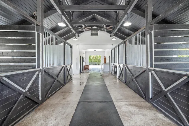 a view of a patio with table and chairs potted plants and large tree