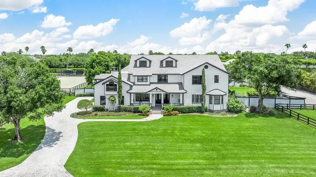 a living room with patio furniture and a potted plant