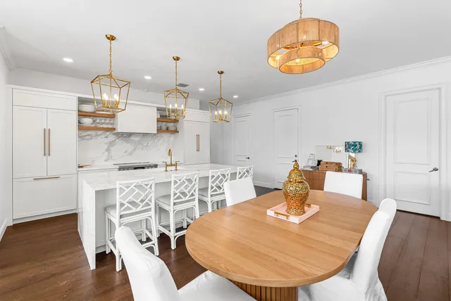 a large kitchen with a table and chairs