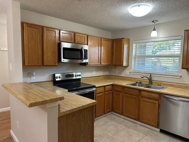 a kitchen with a sink stove and microwave