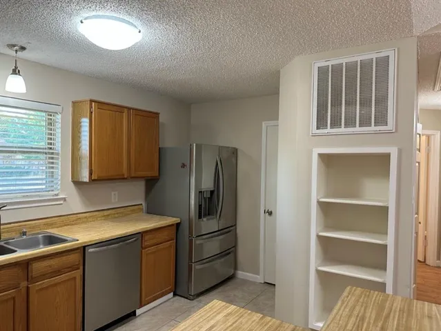 a kitchen with a refrigerator and a sink
