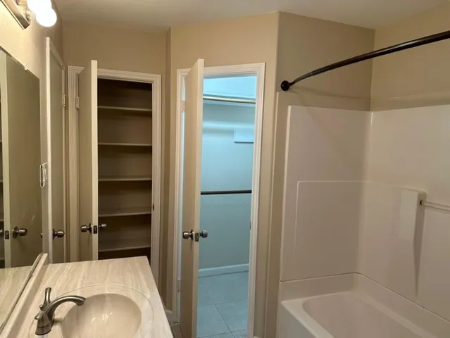 a bathroom with a tub and a shower