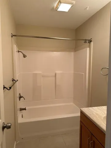 a bathroom with a shower and a bath tub