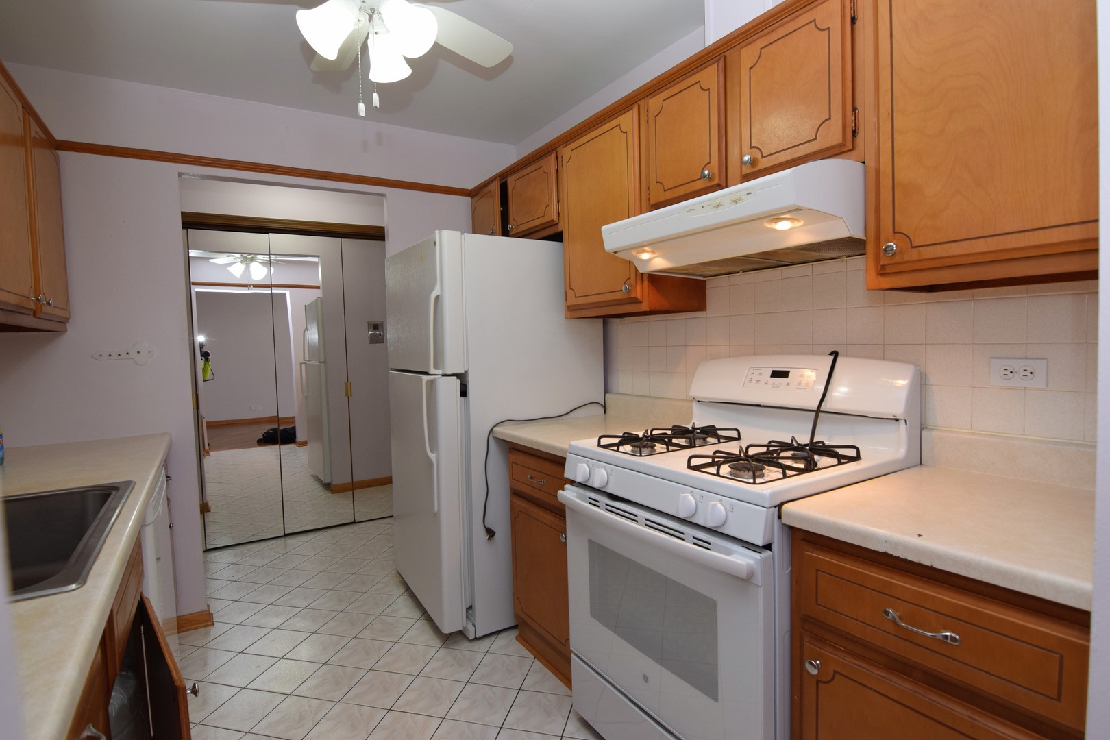 2400 Archbury Lane, Unit 2H Park Ridge, IL 60068 - Photo 2 of 26 a kitchen with stainless steel appliances granite countertop a stove and a refrigerator