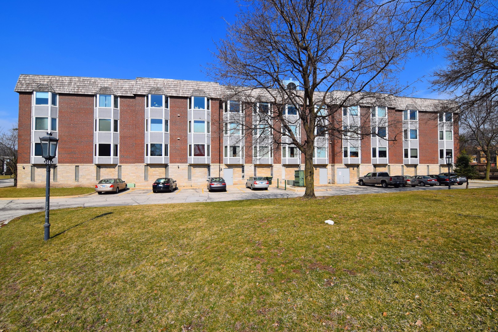 2400 Archbury Lane, Unit 2H Park Ridge, IL 60068 - Photo 20 of 26 a view of a building with a yard