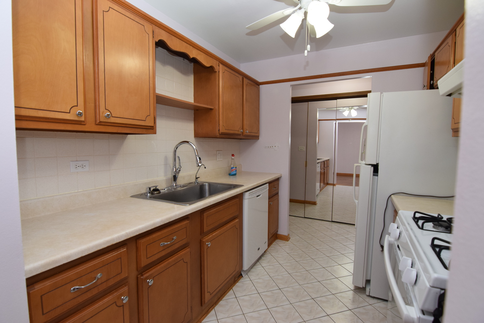 2400 Archbury Lane, Unit 2H Park Ridge, IL 60068 - Photo 3 of 26 a kitchen with stainless steel appliances granite countertop a sink refrigerator and cabinets