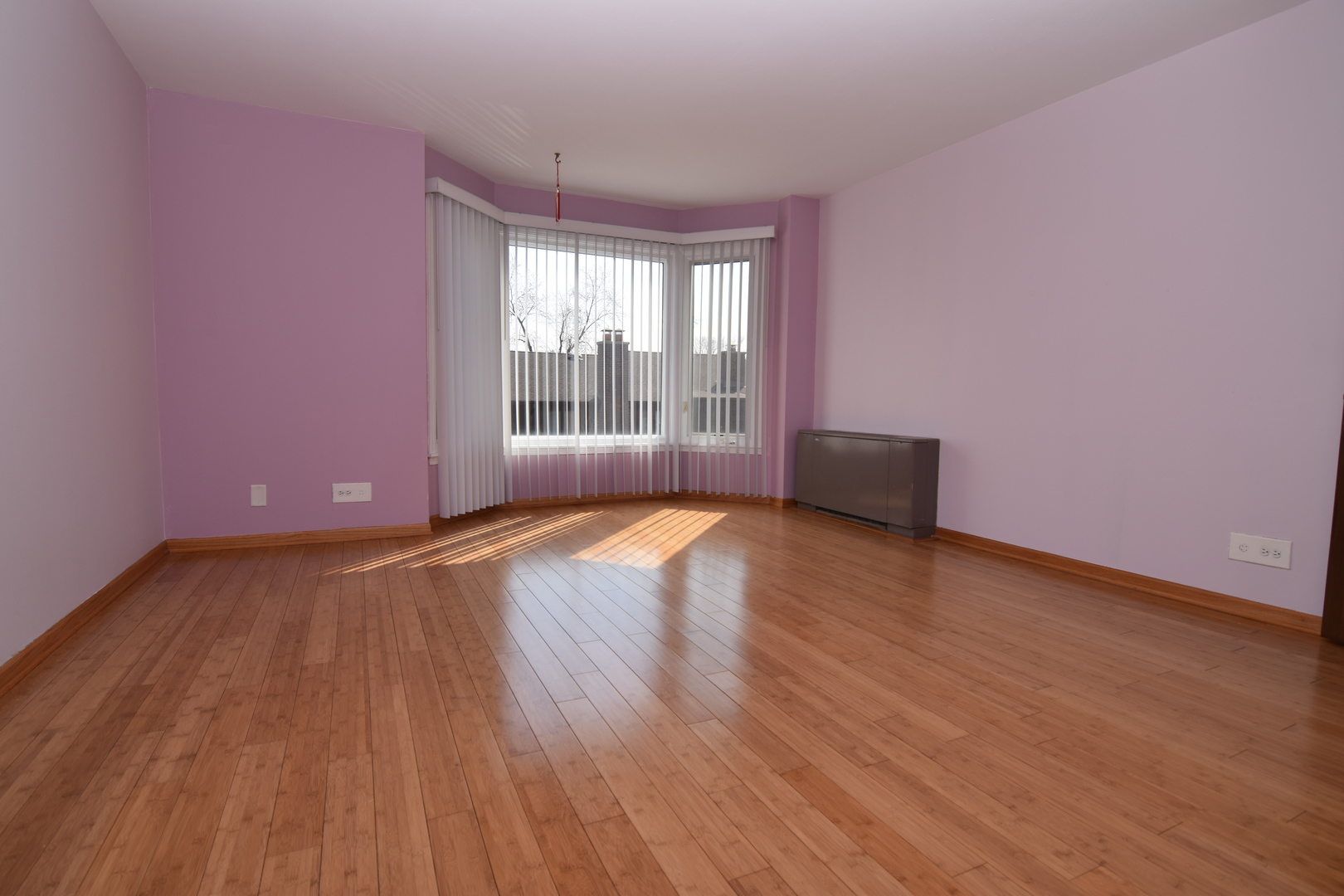 2400 Archbury Lane, Unit 2H Park Ridge, IL 60068 - Photo 8 of 26 an empty room with wooden floor and windows