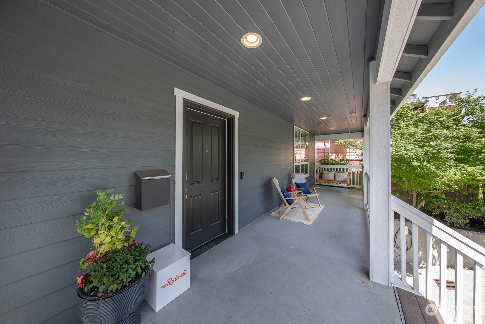 319 18th Avenue Seattle, WA 98122 - Photo 4 of 38 a view of a porch with chairs and potted plants