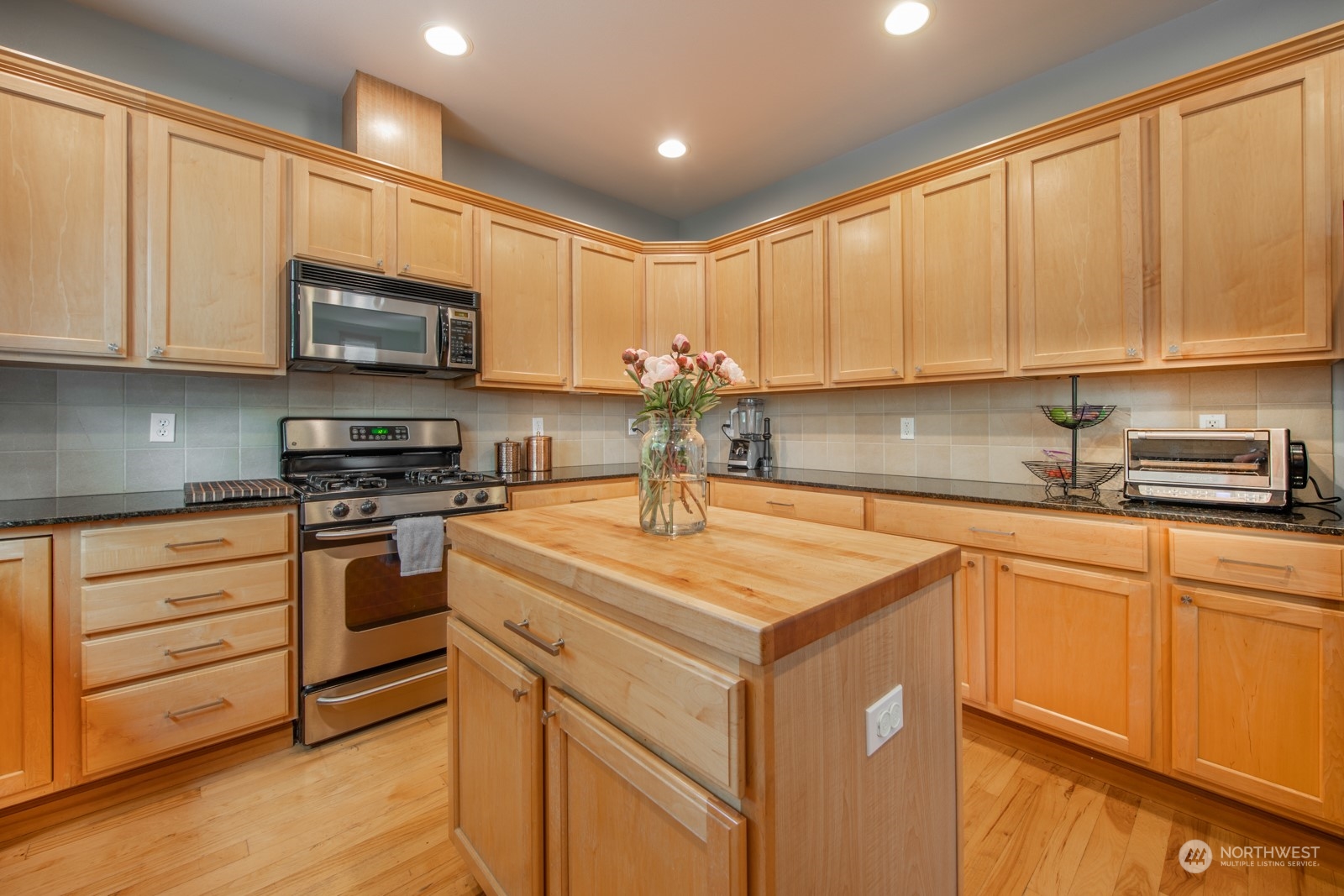 319 18th Avenue Seattle, WA 98122 - Photo 8 of 38 a kitchen with stainless steel appliances granite countertop a sink a stove and a refrigerator