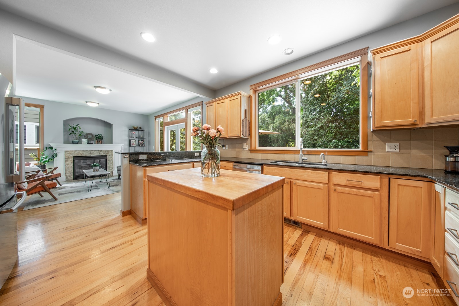319 18th Avenue Seattle, WA 98122 - Photo 9 of 38 a kitchen with a sink stove and wooden cabinets