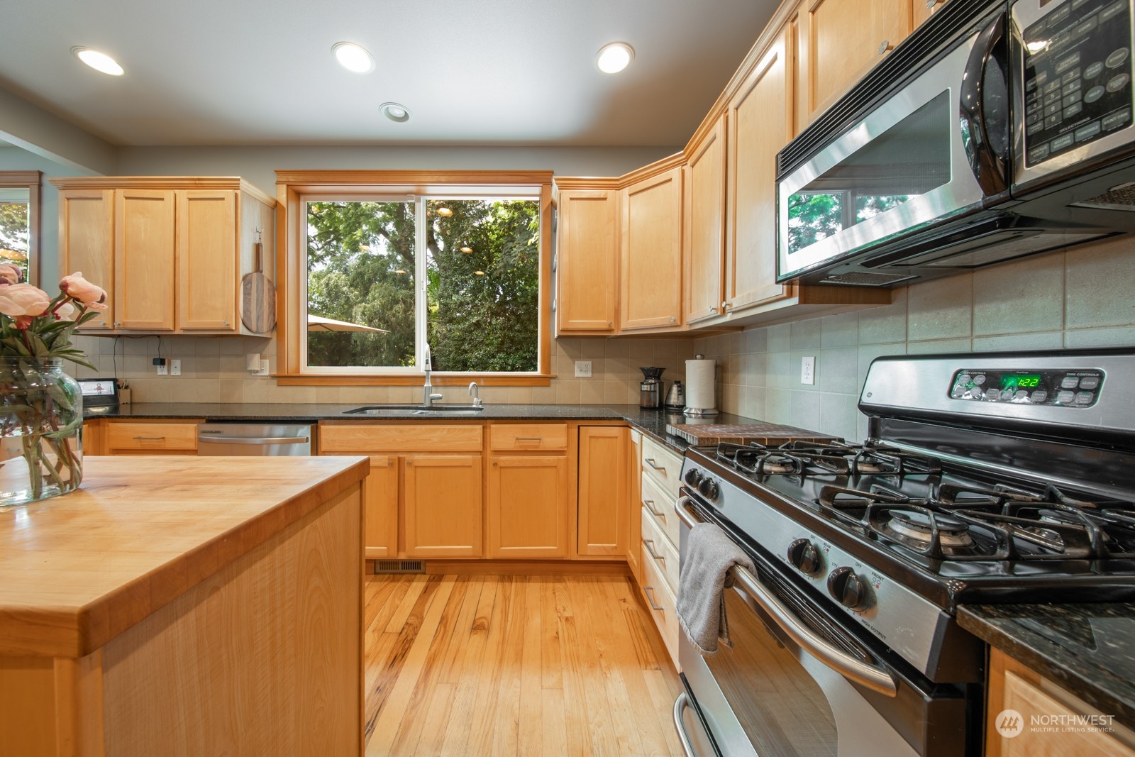 319 18th Avenue Seattle, WA 98122 - Photo 10 of 38 a kitchen with stainless steel appliances granite countertop a stove and a sink