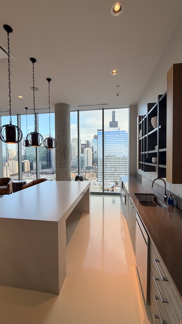 205 South Peoria Street, Unit 1515 Chicago, IL 60607 - Photo 11 of 17 a large kitchen with kitchen island a large window in it