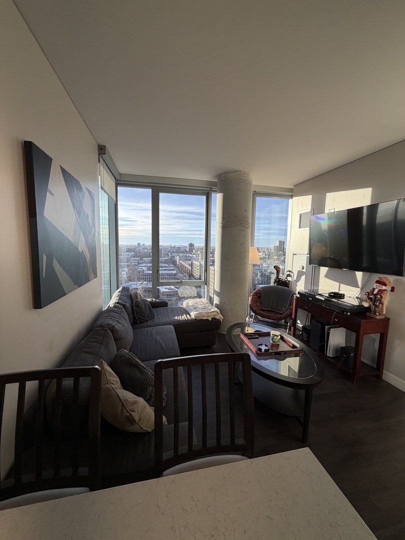 205 South Peoria Street, Unit 1515 Chicago, IL 60607 - Photo 14 of 17 a living room with furniture and a flat screen tv