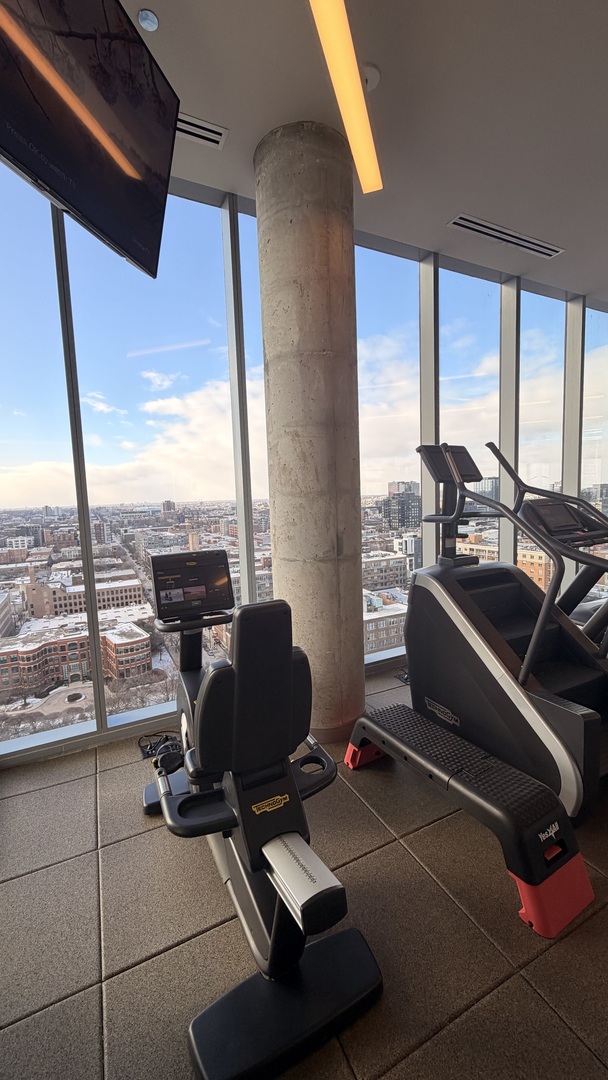 205 South Peoria Street, Unit 1515 Chicago, IL 60607 - Photo 9 of 17 a room with gym equipment and a large window