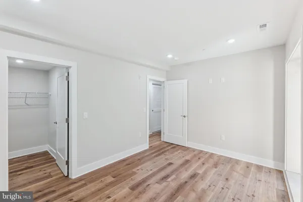 a view of hallway with wooden floor