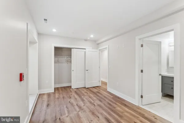 a view of hallway with wooden floor