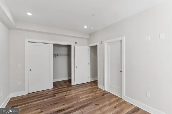 a view of hallway with wooden floor