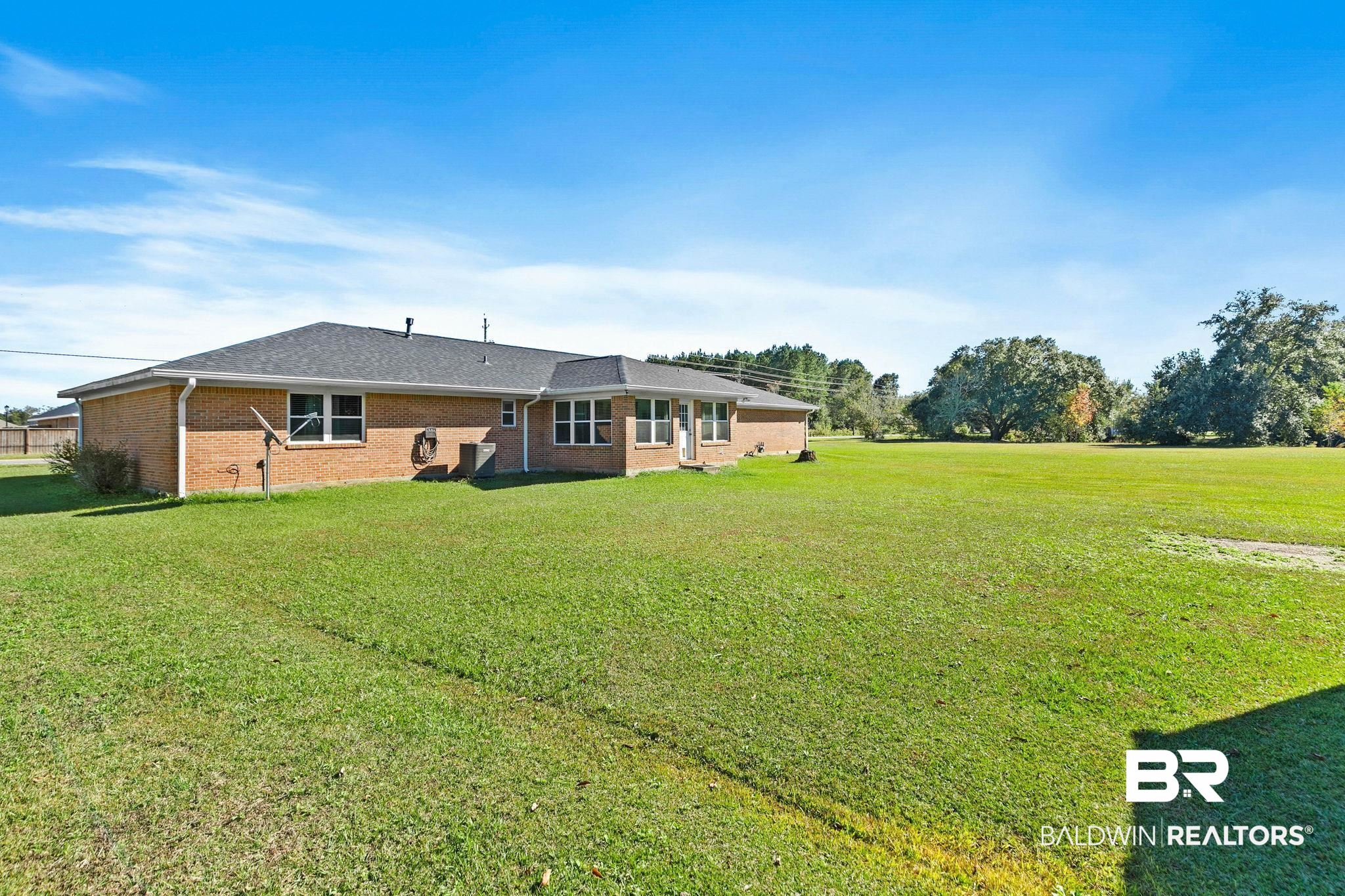 1510 South Juniper Street Foley, AL 36535 - Photo 29 of 36 Back of property with a yard, brick siding, and a shingled roof