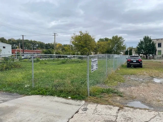 a view of a lake with a big yard and large trees