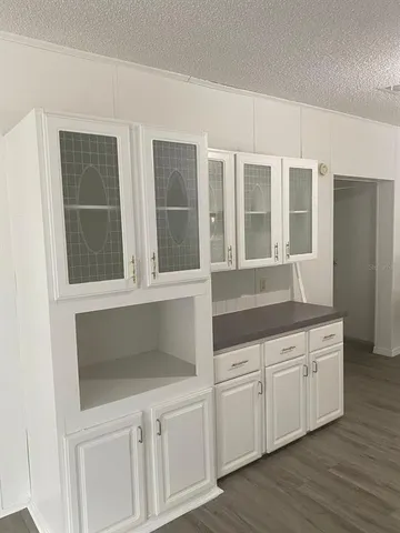 a kitchen with white cabinets and a sink