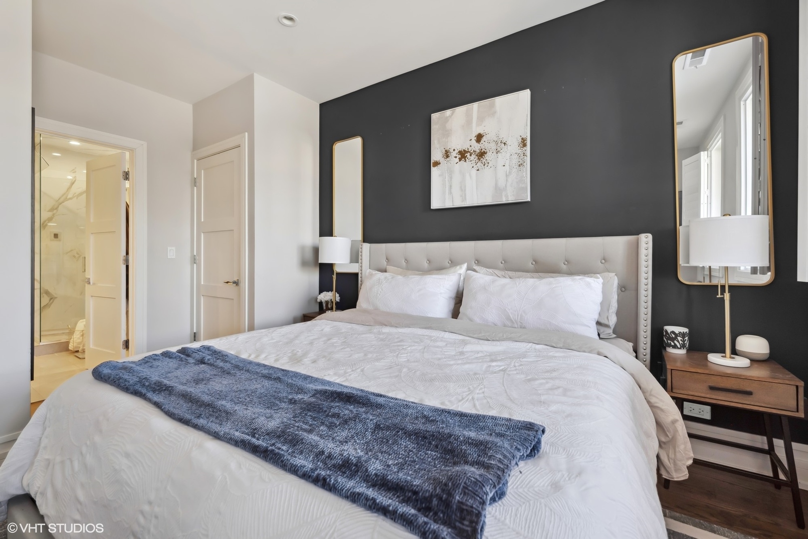 1448 West Chestnut Street, Unit 2 Chicago, IL 60642 - Photo 14 of 20 a bedroom with a bed and a lamp on table