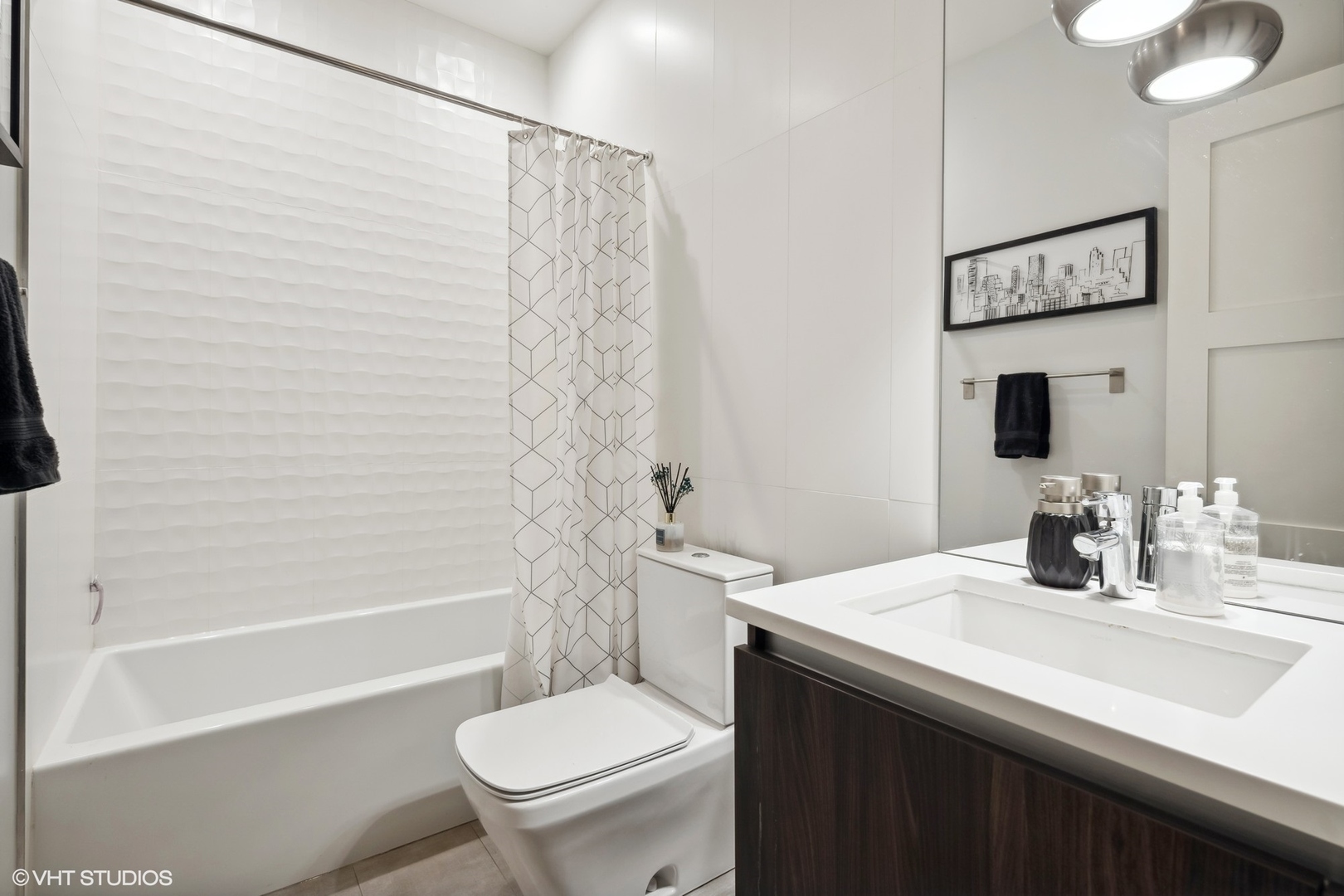 1448 West Chestnut Street, Unit 2 Chicago, IL 60642 - Photo 18 of 20 a bathroom with a sink a toilet and shower
