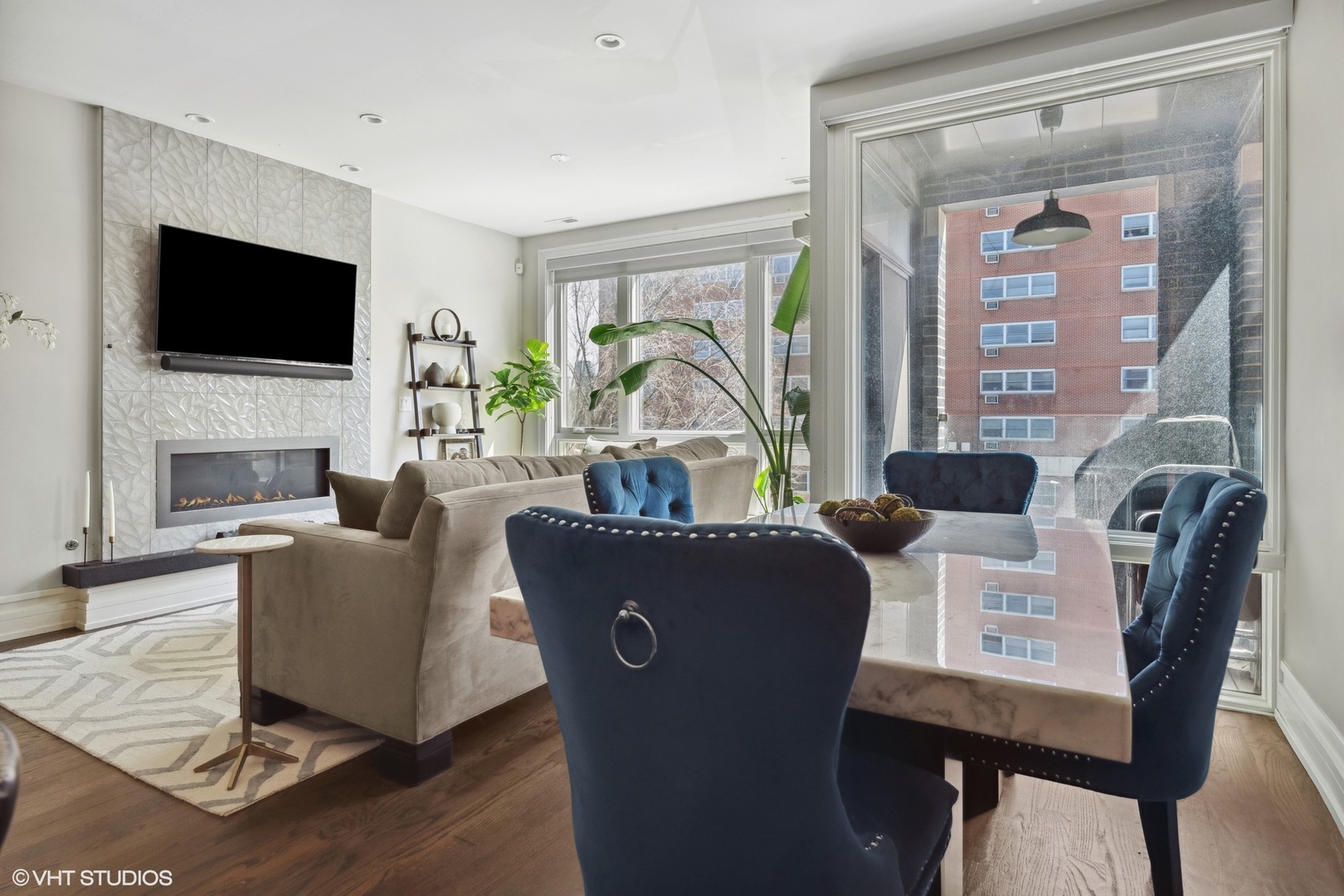 1448 West Chestnut Street, Unit 2 Chicago, IL 60642 - Photo 6 of 20 a living room with furniture a flat screen tv and a fireplace