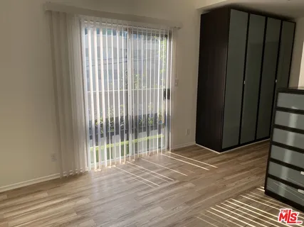a view of wooden floor and a window in an empty room