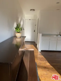 a hallway with a potted plant in front of it