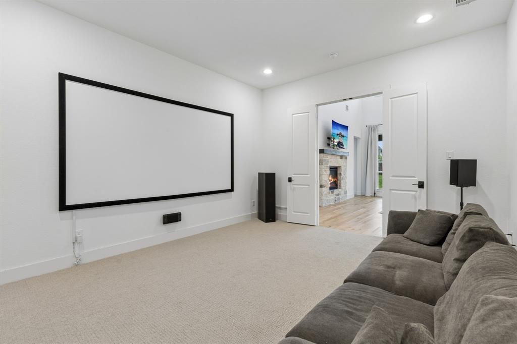 566 Broadleaf Way Haslet, TX 76052 - Photo 22 of 38 Dedicated entertainment space featuring a large projection screen and recessed lighting