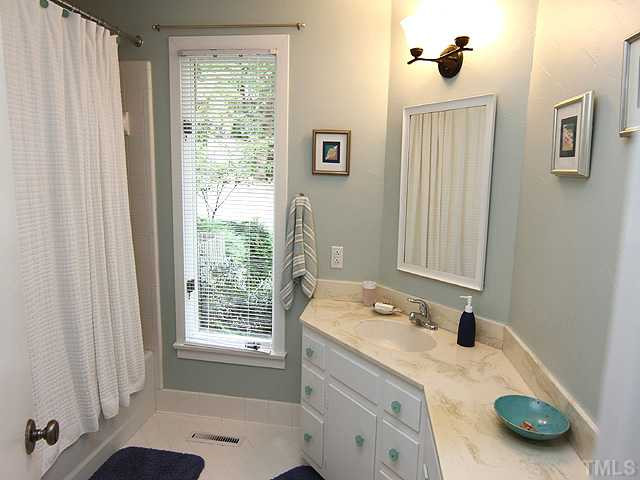 5407 Springfield Drive Raleigh, NC 27609 - Photo 18 of 24 Ensuite bath has large window.