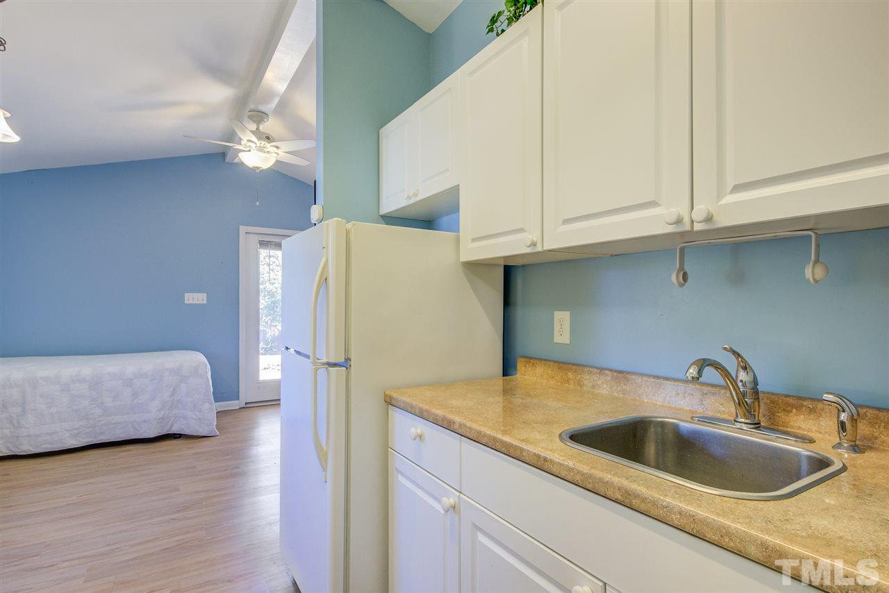3424 Wade Avenue Raleigh, NC 27607 - Photo 21 of 30 a kitchen with refrigerator and cabinets