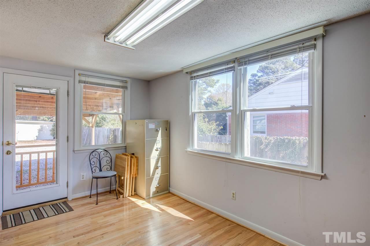 3424 Wade Avenue Raleigh, NC 27607 - Photo 7 of 30 a view of an empty room with wooden floor and a window