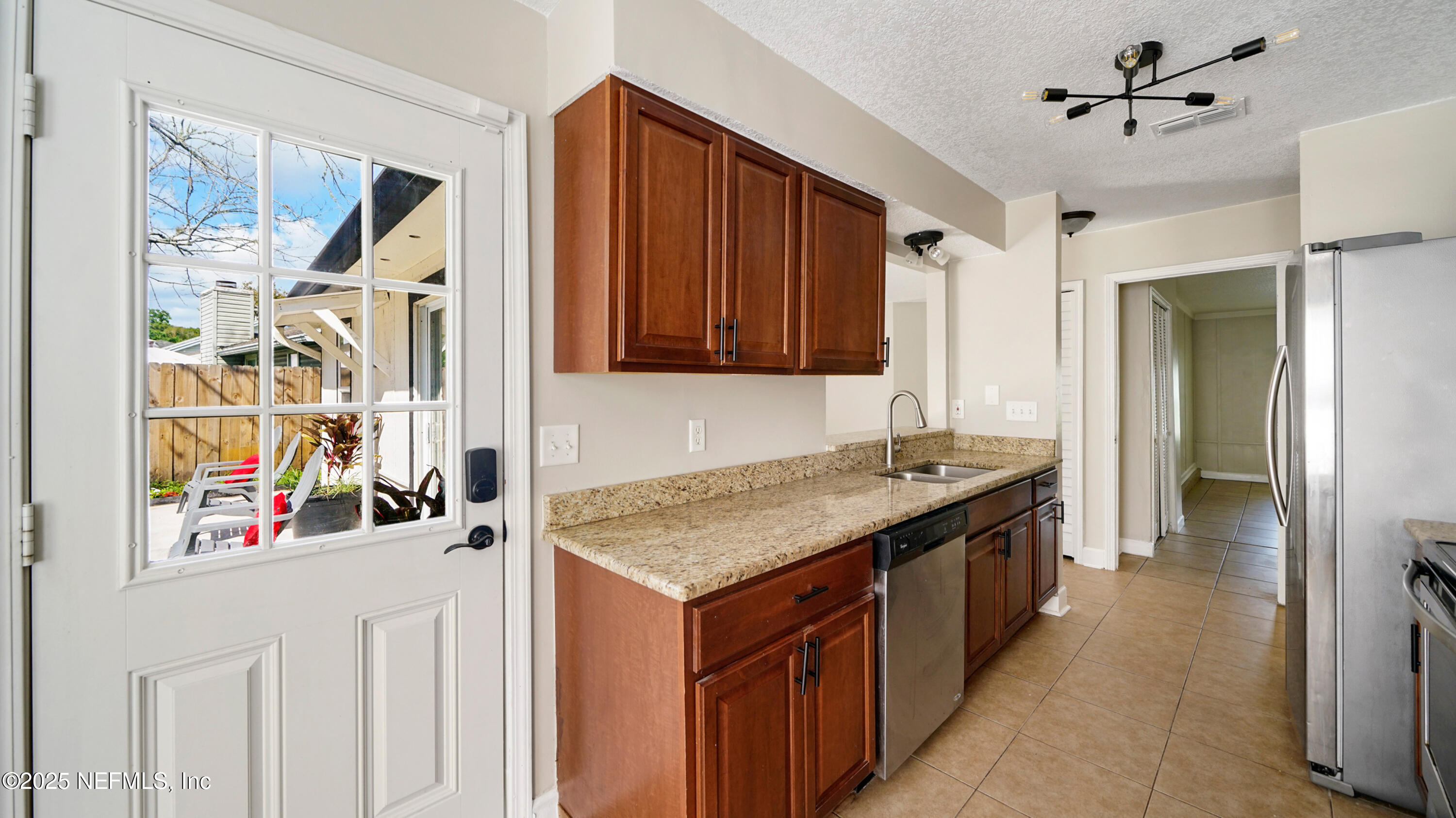 3255 Dowitcher Lane Orange Park, FL 32065 - Photo 11 of 27 a kitchen with stainless steel appliances granite countertop a stove and a refrigerator