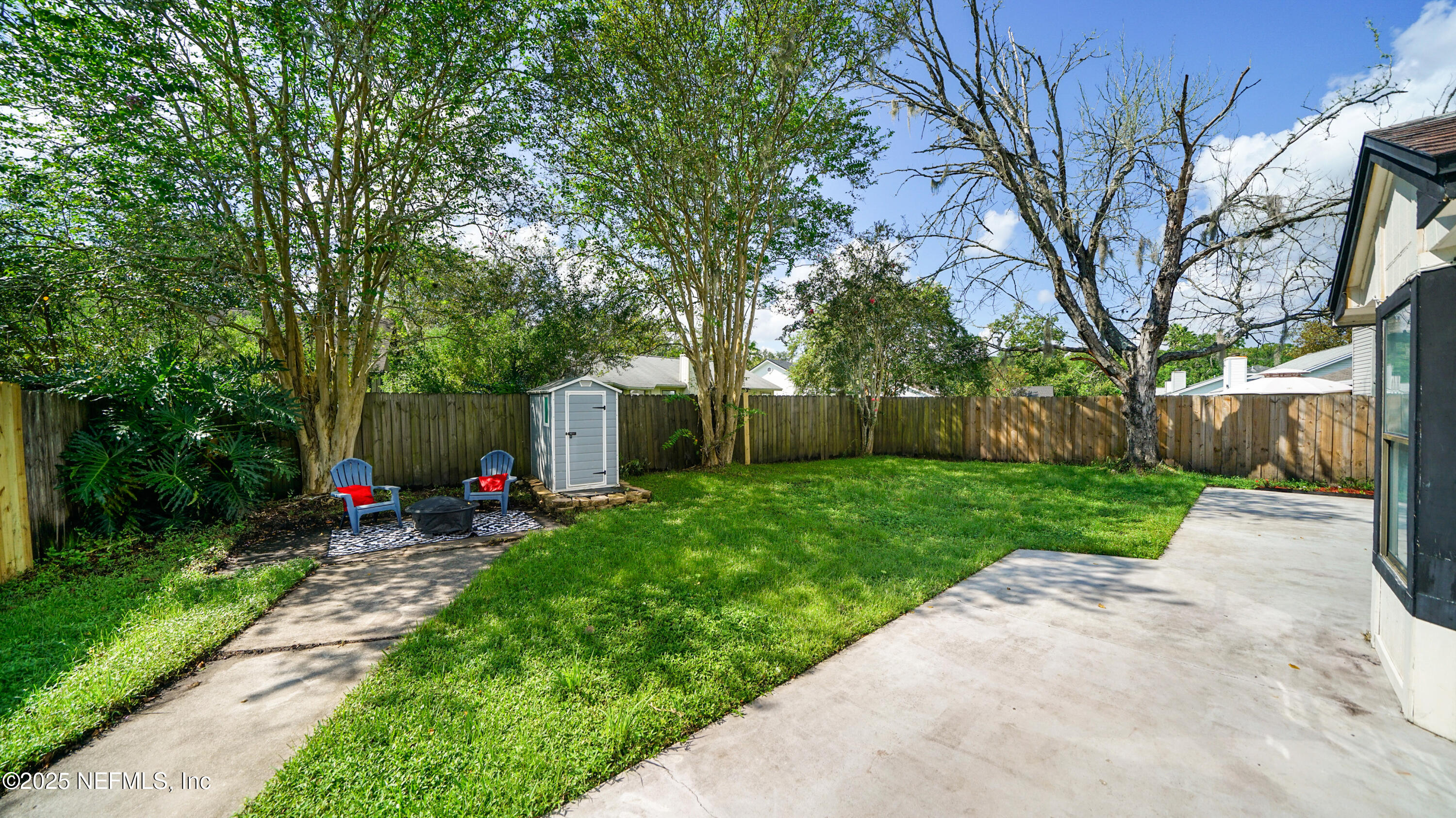 3255 Dowitcher Lane Orange Park, FL 32065 - Photo 25 of 27 a view of a yard with a large tree and a fence