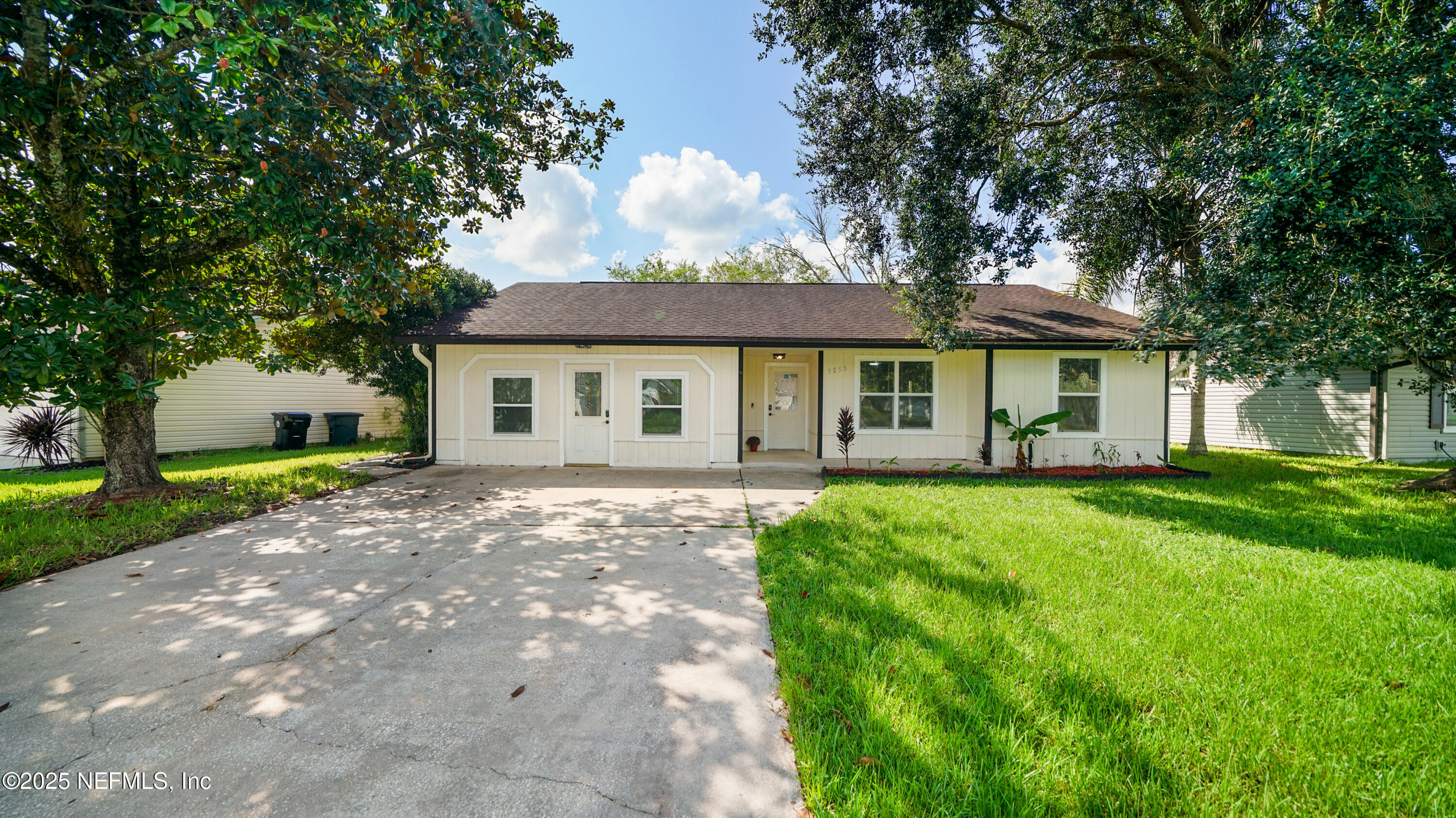 3255 Dowitcher Lane Orange Park, FL 32065 - Photo 26 of 27 a view of a yard in front of a house with plants and large tree