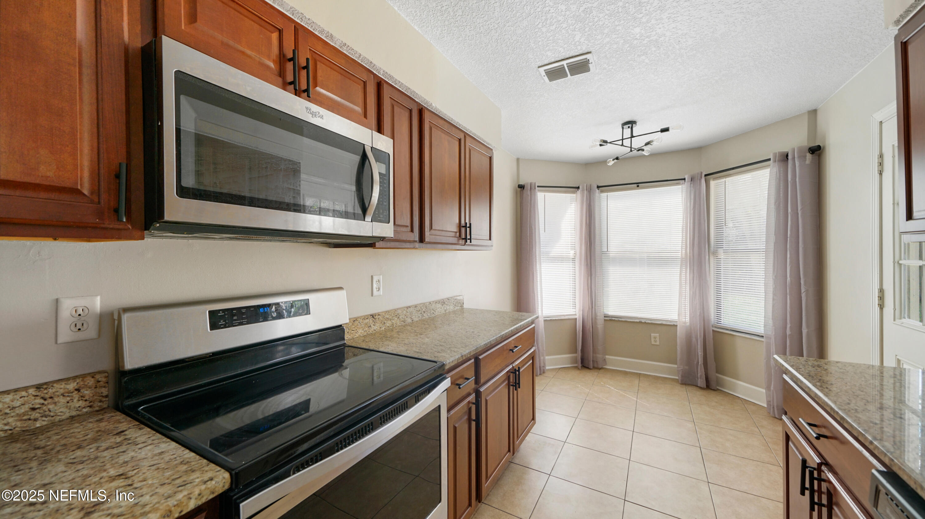 3255 Dowitcher Lane Orange Park, FL 32065 - Photo 4 of 27 a kitchen with a stove and a microwave