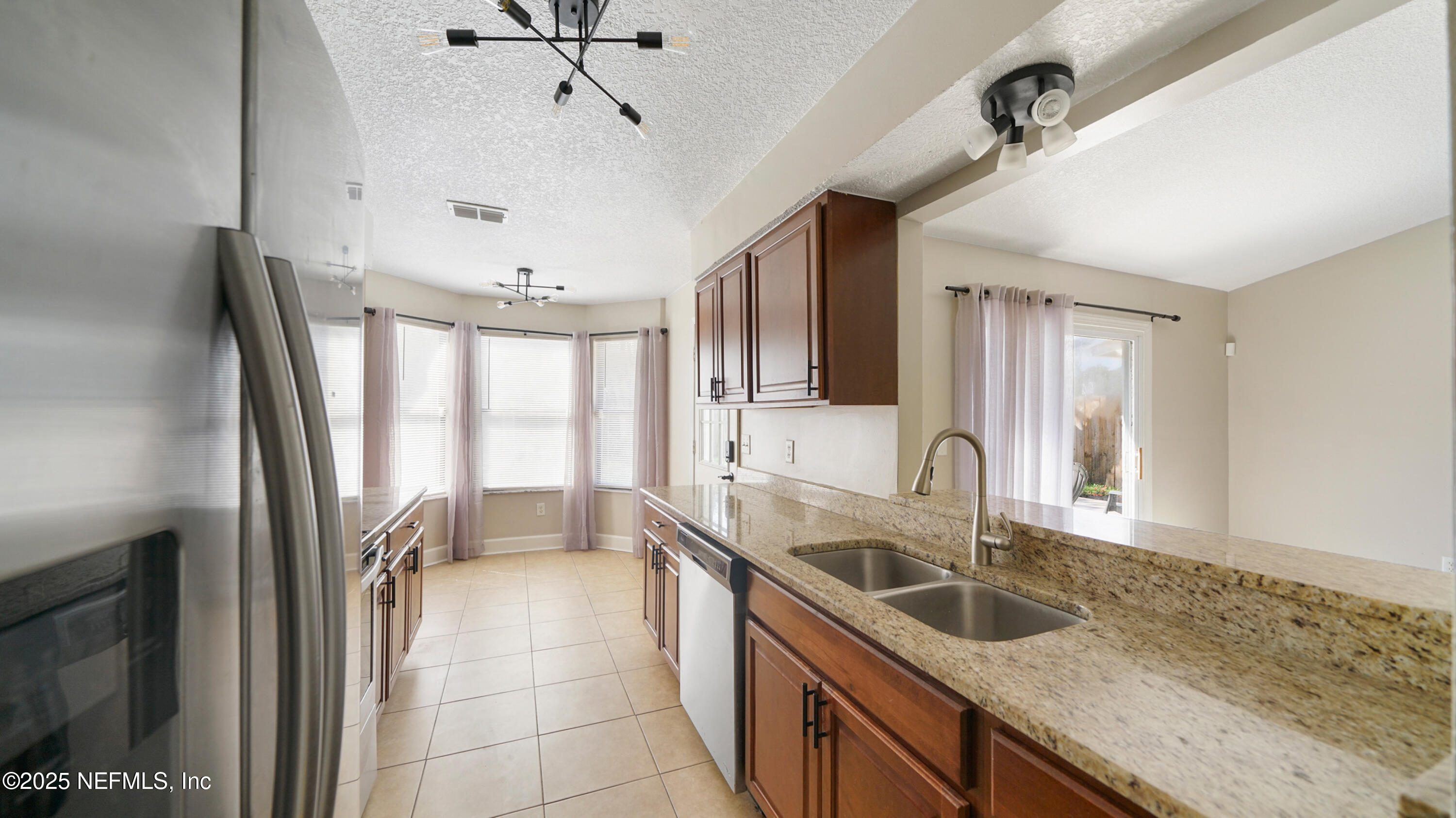 3255 Dowitcher Lane Orange Park, FL 32065 - Photo 10 of 27 a kitchen with granite countertop a sink a counter top space appliances and cabinets