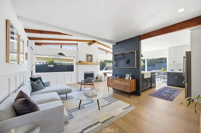 a living room with fireplace furniture and a large window