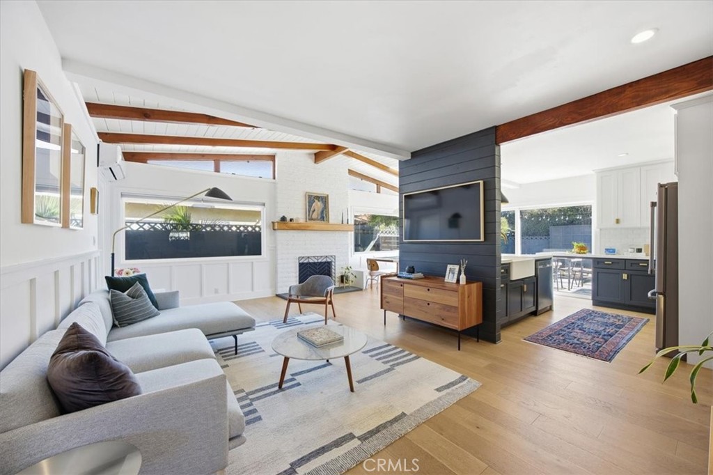 a living room with fireplace furniture and a large window