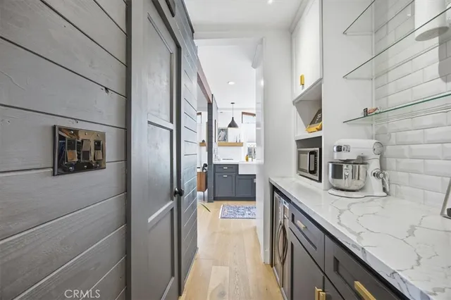 a kitchen with stainless steel appliances granite countertop a sink and a refrigerator