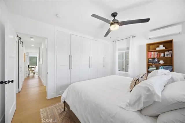 a spacious bedroom with a bed and a walk in closet