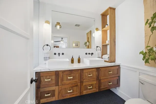 a bathroom with a sink vanity granite and a mirror