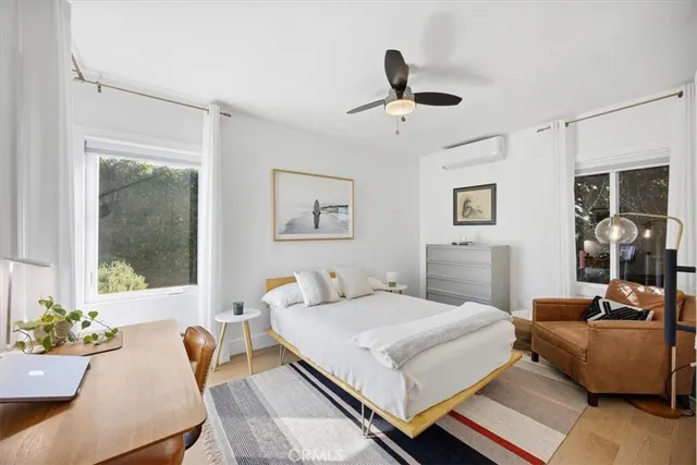 a bedroom with a bed and wooden floor