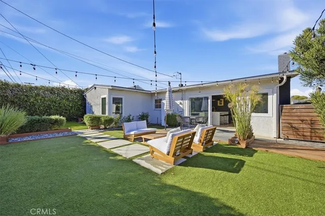 a view of a house with backyard porch and sitting area