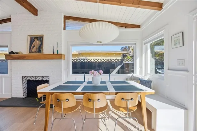 a living room with a table chairs and a fireplace