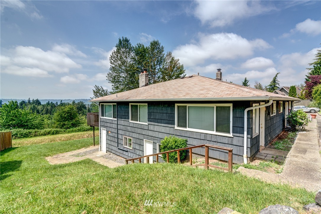 19215 98th Avenue South Renton, WA 98055 - Photo 2 of 23 a front view of a house with a yard table and chairs