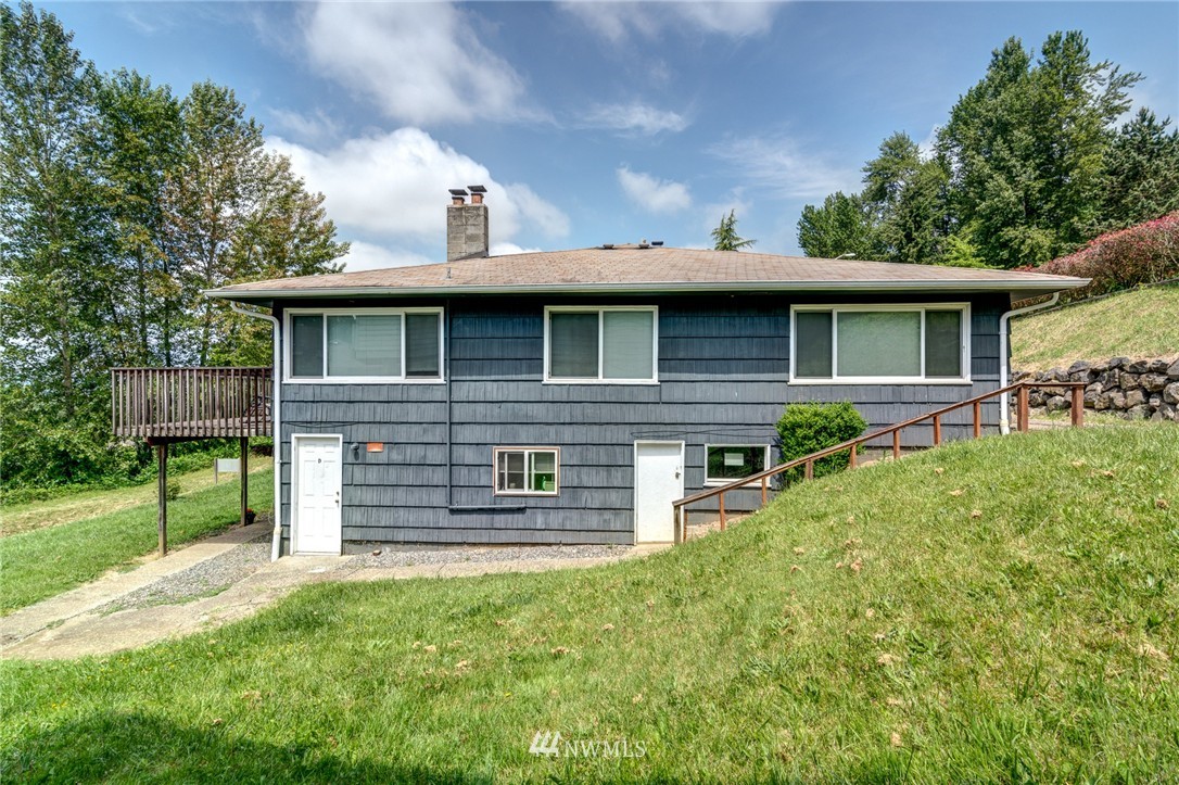 19215 98th Avenue South Renton, WA 98055 - Photo 3 of 23 a front view of a house with a garden