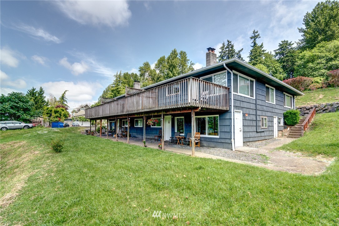 19215 98th Avenue South Renton, WA 98055 - Photo 4 of 23 a front view of a house with a garden and trees