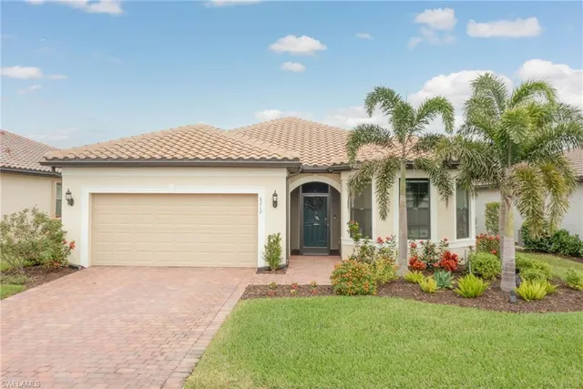 a front view of a house with a garden and plants